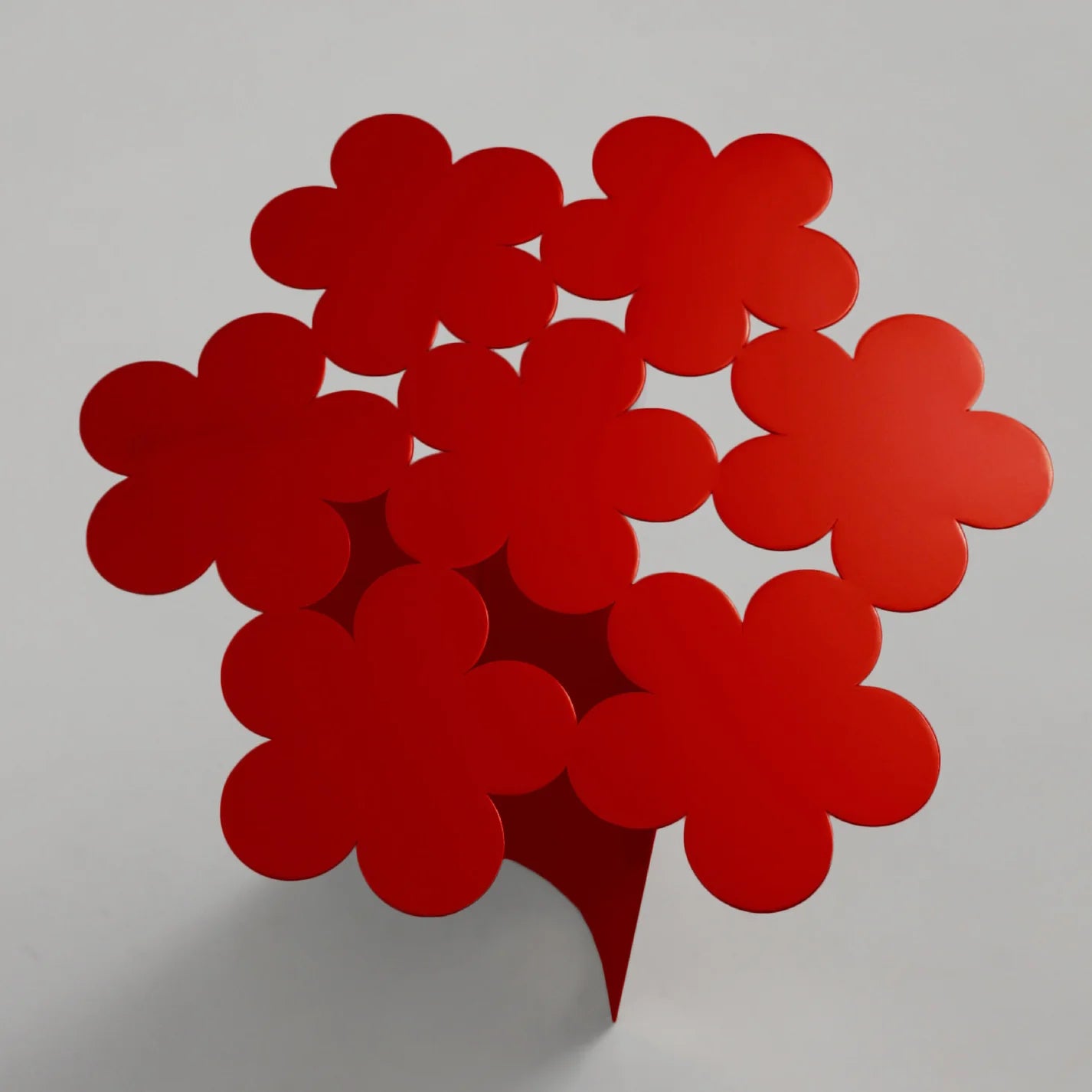 Red flower-shaped object on a gray background
